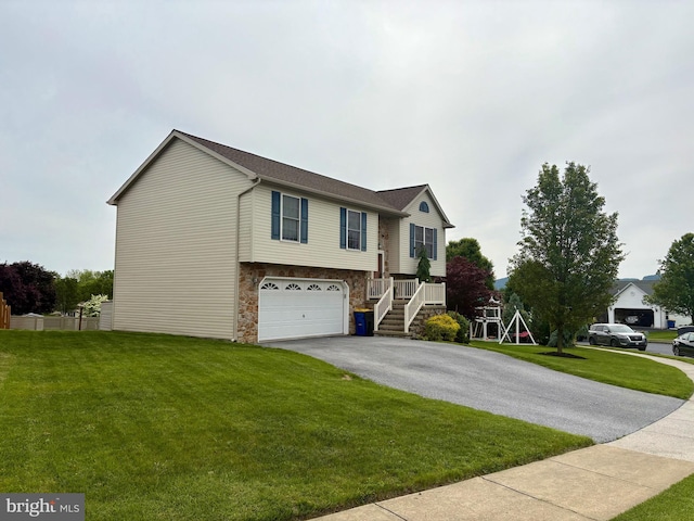 21 Georgie Ln, Richland, PA 17087 - view of front facade with driveway, an attached garage, a front lawn, and stone siding