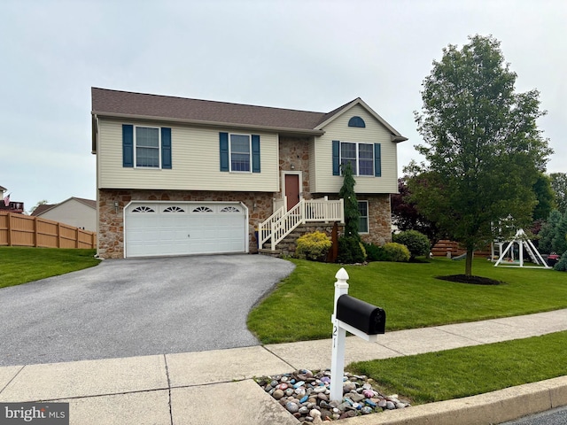 21 Georgie Ln, Richland, PA 17087 - split foyer home featuring stone siding, a garage, and asphalt driveway