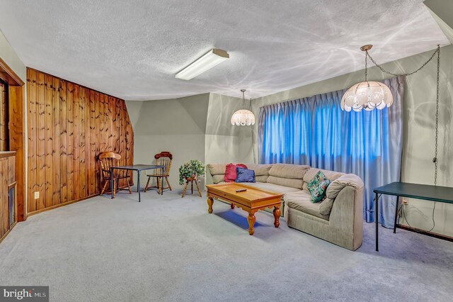 865 Windsor Perrineville Rd, East Windsor, NJ 08520 - living room featuring a chandelier, carpet flooring, a textured ceiling, and wood walls