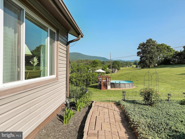 123 Windy Meadows Ct, Front Royal, VA 22630 - view of grassy yard featuring a mountain view and an outdoor pool