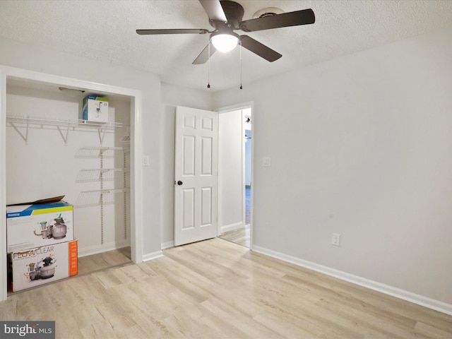 123 Windy Meadows Ct, Front Royal, VA 22630 - unfurnished bedroom with wood finished floors, a textured ceiling, a closet, baseboards, and ceiling fan
