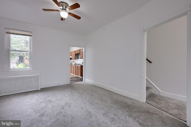 547 W Vine St, Lancaster, PA 17603 - carpeted empty room featuring radiator heating unit, a ceiling fan, baseboards, and stairs