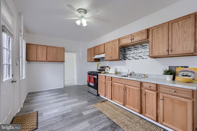 547 W Vine St, Lancaster, PA 17603 - kitchen with gas range, under cabinet range hood, a sink, ceiling fan, and light countertops