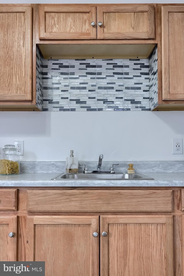 547 W Vine St, Lancaster, PA 17603 - kitchen featuring a sink, light countertops, and backsplash