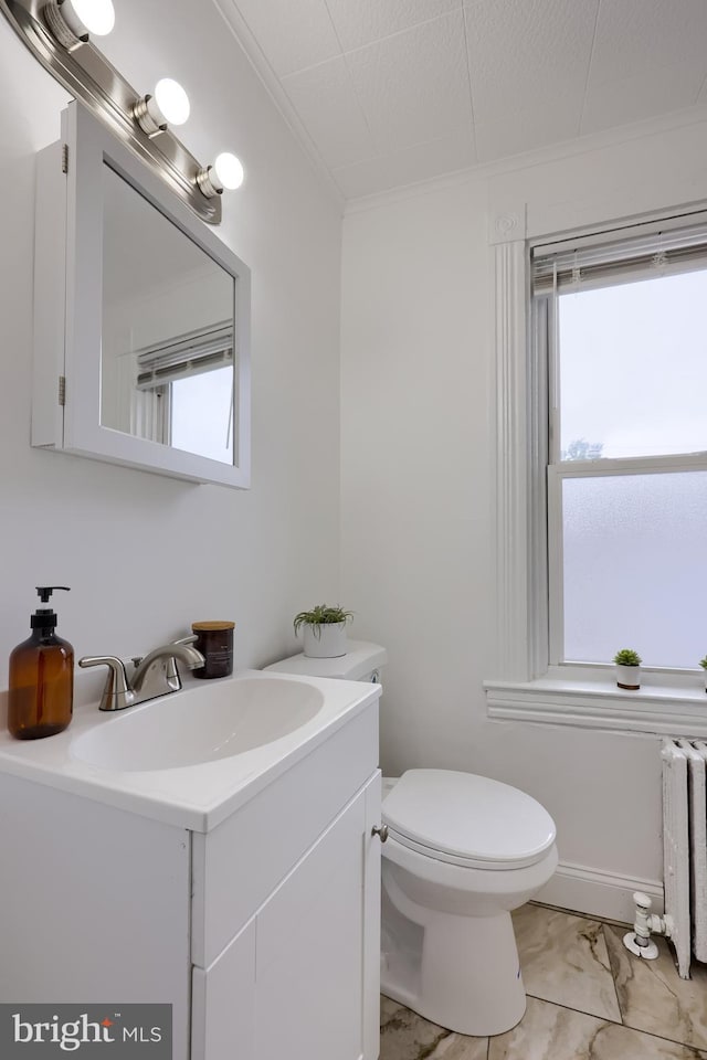 547 W Vine St, Lancaster, PA 17603 - half bathroom with vanity, crown molding, marble look tiles, healthy amount of natural light, and toilet