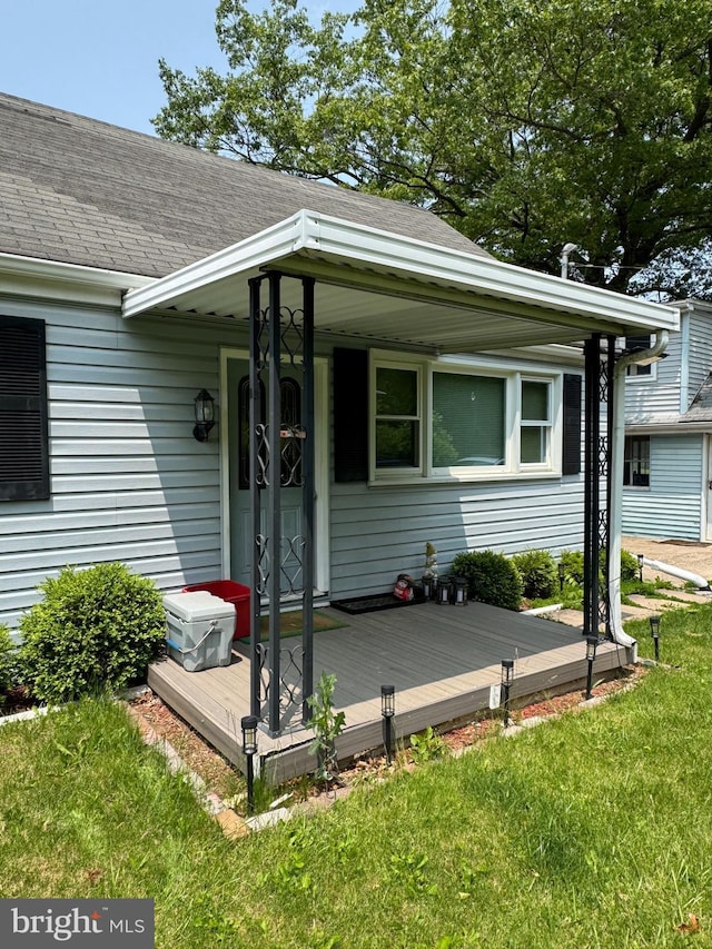 1238 Fox Hill Rd, State College, PA 16803 - property entrance featuring roof with shingles, a lawn, and a deck
