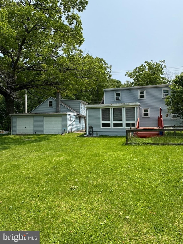 1238 Fox Hill Rd, State College, PA 16803 - rear view of property featuring a garage, a yard, an outdoor structure, and view of wooded area