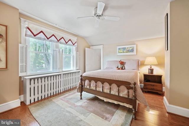 103 E Monroe Ave, Alexandria, VA 22301 - bedroom featuring lofted ceiling, wood finished floors, a ceiling fan, and radiator heating unit