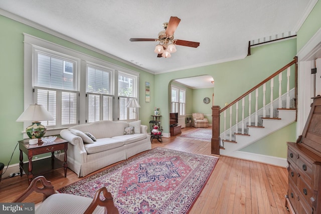103 E Monroe Ave, Alexandria, VA 22301 - living area with arched walkways, crown molding, wood-type flooring, and a ceiling fan