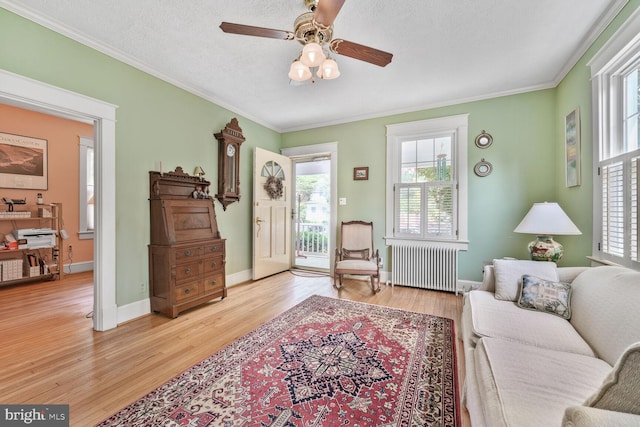 103 E Monroe Ave, Alexandria, VA 22301 - living area with radiator, crown molding, wood finished floors, and ceiling fan