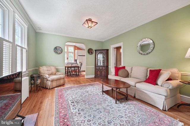 103 E Monroe Ave, Alexandria, VA 22301 - living area with arched walkways, plenty of natural light, crown molding, and hardwood / wood-style floors