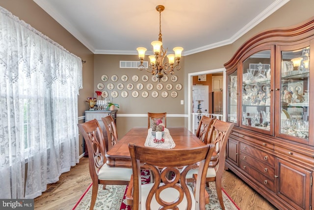 8 Adams Ln, Hainesport, NJ 08036 - dining area featuring light wood-type flooring, ornamental molding, and a chandelier