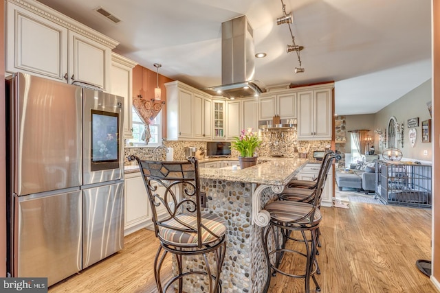8 Adams Ln, Hainesport, NJ 08036 - kitchen featuring smart refrigerator, island exhaust hood, cream cabinetry, light stone countertops, and light wood-style flooring
