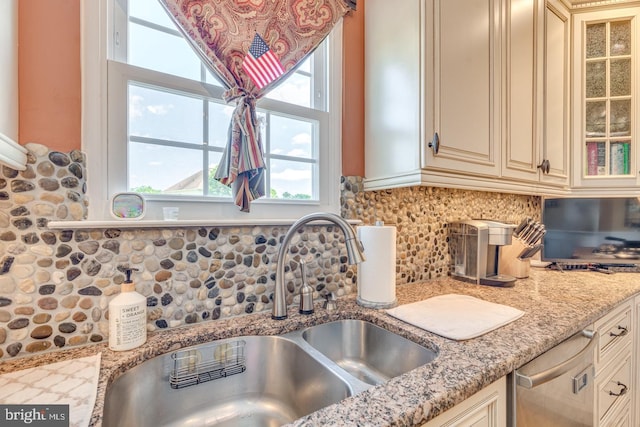 8 Adams Ln, Hainesport, NJ 08036 - kitchen featuring cream cabinets, stainless steel dishwasher, a sink, glass insert cabinets, and light stone counters
