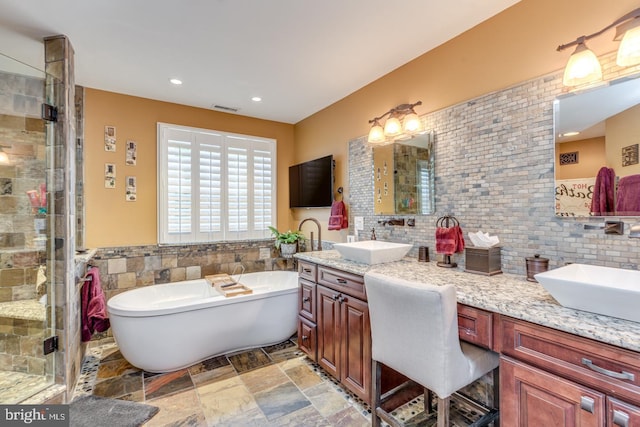 8 Adams Ln, Hainesport, NJ 08036 - bathroom featuring double vanity, a freestanding bath, tile walls, a shower stall, and stone finish flooring