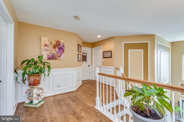 8 Adams Ln, Hainesport, NJ 08036 - hall with an upstairs landing, wood finished floors, a wainscoted wall, recessed lighting, and a decorative wall