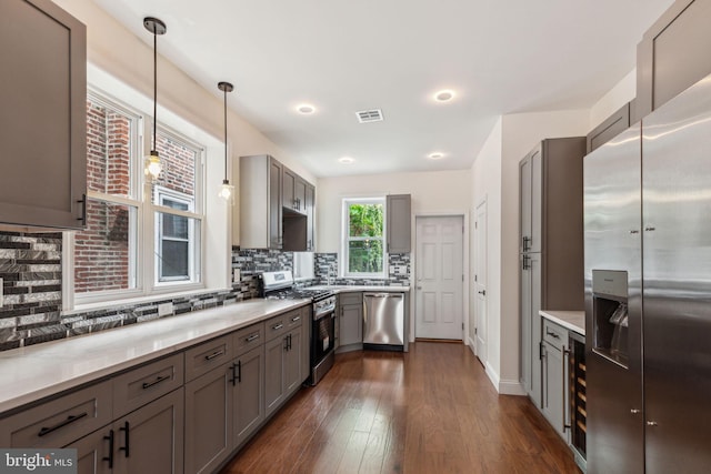 5724 Pine St, Philadelphia, PA 19143 - kitchen with stainless steel appliances, gray cabinetry, wine cooler, decorative backsplash, and dark wood-style flooring