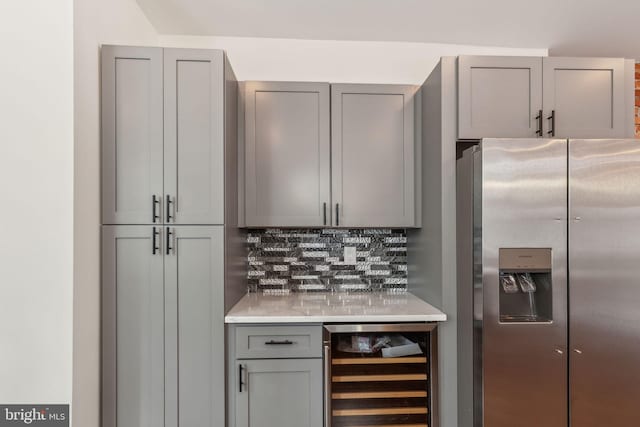 5724 Pine St, Philadelphia, PA 19143 - kitchen featuring stainless steel fridge, wine cooler, gray cabinets, decorative backsplash, and light countertops