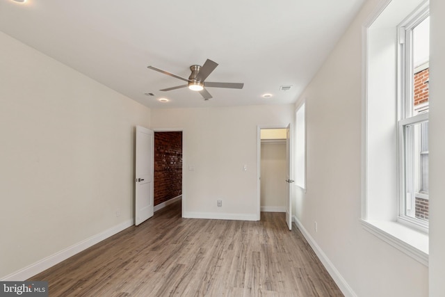 5724 Pine St, Philadelphia, PA 19143 - unfurnished bedroom with light wood-style floors, a spacious closet, baseboards, a closet, and a ceiling fan