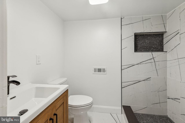 5724 Pine St, Philadelphia, PA 19143 - full bathroom with toilet, marble look tile flooring, vanity, tiled shower, and baseboards