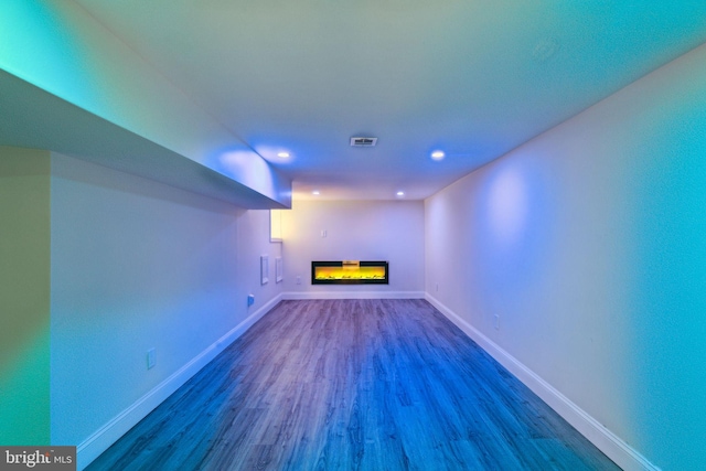 5724 Pine St, Philadelphia, PA 19143 - unfurnished living room with dark wood-style floors, a glass covered fireplace, baseboards, and recessed lighting