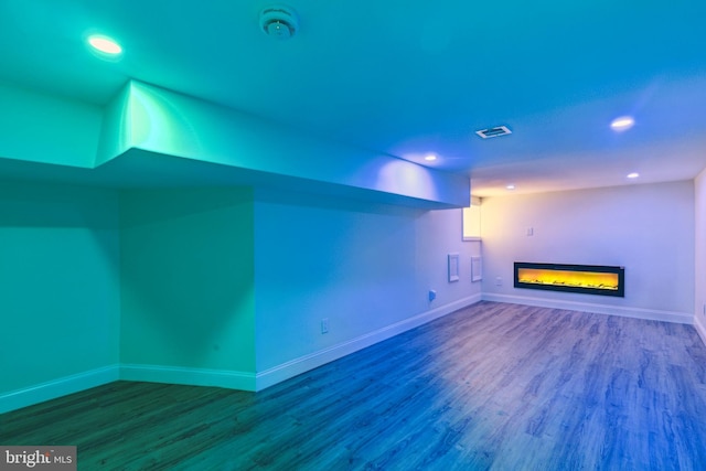 5724 Pine St, Philadelphia, PA 19143 - unfurnished living room featuring wood finished floors, a glass covered fireplace, baseboards, and recessed lighting