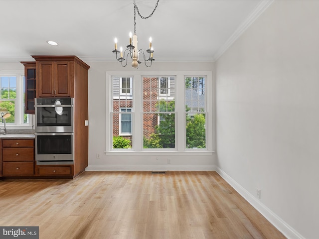 138 Park Side Cir, Ocean Pines, MD 21811 - kitchen featuring stainless steel double oven, a chandelier, brown cabinetry, crown molding, and light wood-style flooring