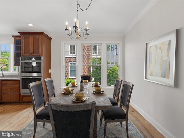 138 Park Side Cir, Ocean Pines, MD 21811 - dining room featuring a chandelier, ornamental molding, and light wood-style flooring