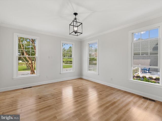 138 Park Side Cir, Ocean Pines, MD 21811 - unfurnished room with crown molding, a chandelier, and light wood-type flooring