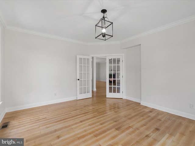 138 Park Side Cir, Ocean Pines, MD 21811 - unfurnished room featuring french doors, light wood finished floors, ornamental molding, and a chandelier