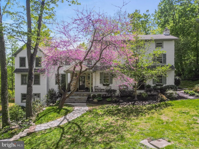 2 Earles Ln, Newtown Square, PA 19073 - view of front facade featuring a front lawn, covered porch, and a chimney