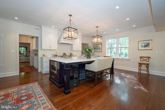 2 Earles Ln, Newtown Square, PA 19073 - kitchen featuring stainless steel microwave, light countertops, white cabinets, a chandelier, and dark wood-style floors