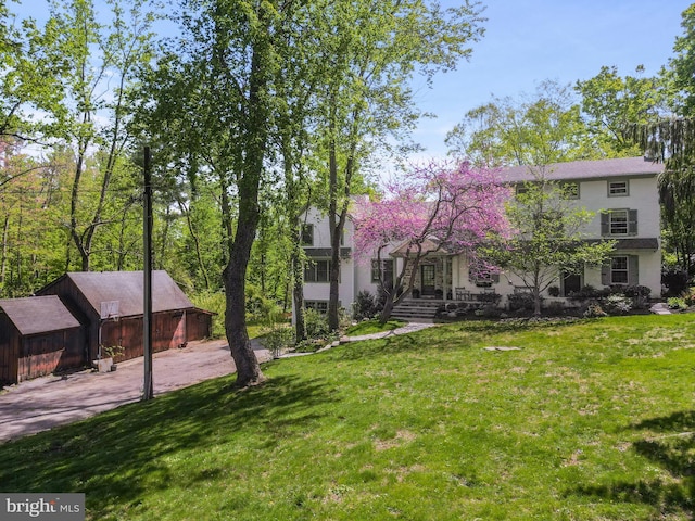 2 Earles Ln, Newtown Square, PA 19073 - view of front facade featuring a front lawn, stucco siding, and an outdoor structure