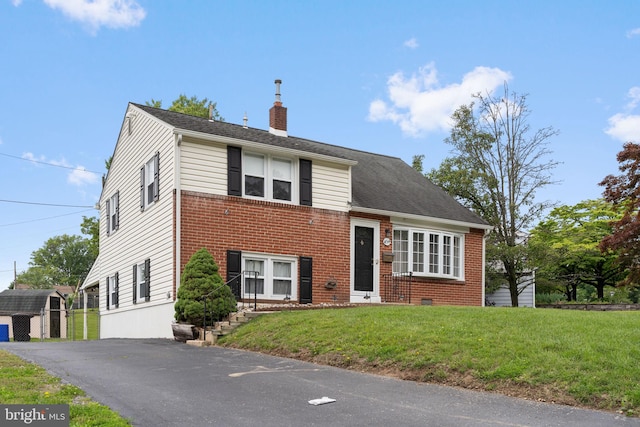 454 N Manor Dr, Media, PA 19063 - split level home featuring a chimney, brick siding, and a front yard