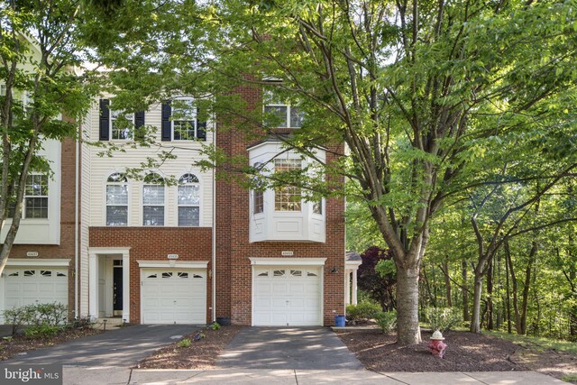 43433 Blair Park Sq, Ashburn, VA 20147 - townhome / multi-family property featuring driveway, a garage, and brick siding