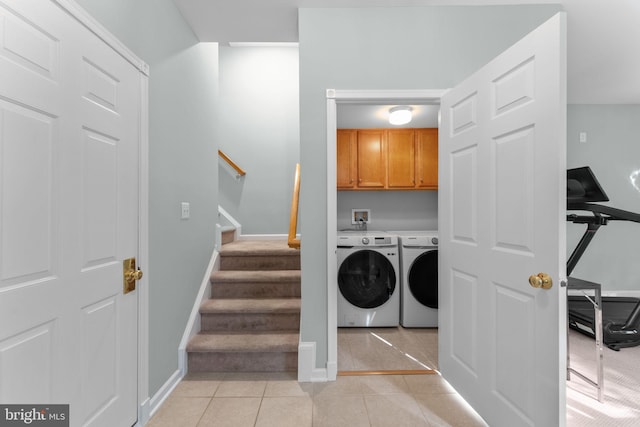 43433 Blair Park Sq, Ashburn, VA 20147 - laundry area featuring cabinet space, washing machine and clothes dryer, light tile patterned flooring, and baseboards