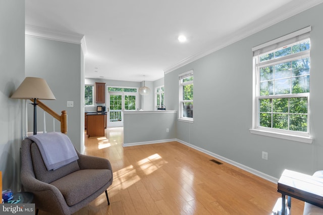 43433 Blair Park Sq, Ashburn, VA 20147 - sitting room featuring ornamental molding, healthy amount of natural light, baseboards, and light wood-style floors