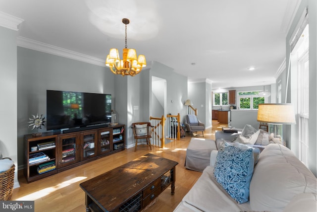 43433 Blair Park Sq, Ashburn, VA 20147 - living room featuring ornamental molding, a chandelier, wood finished floors, stairs, and baseboards