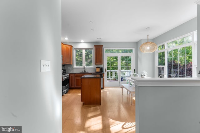 43433 Blair Park Sq, Ashburn, VA 20147 - kitchen featuring stainless steel range with gas stovetop, light wood-style floors, recessed lighting, healthy amount of natural light, and a center island
