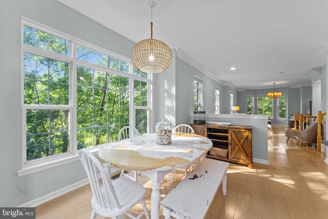 43433 Blair Park Sq, Ashburn, VA 20147 - dining space with a chandelier, baseboards, light wood finished floors, and ornamental molding