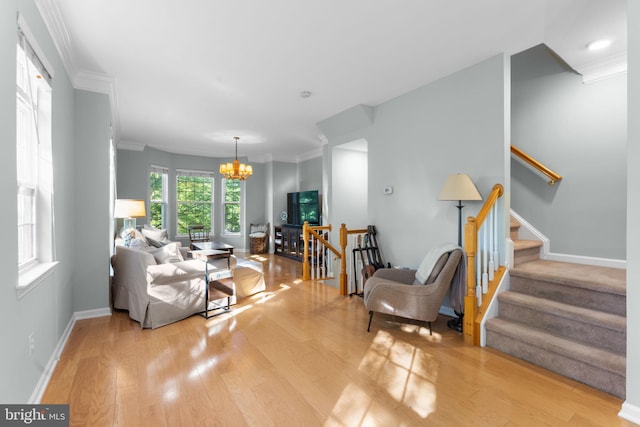 43433 Blair Park Sq, Ashburn, VA 20147 - living area with a chandelier, ornamental molding, light wood-style flooring, stairway, and baseboards