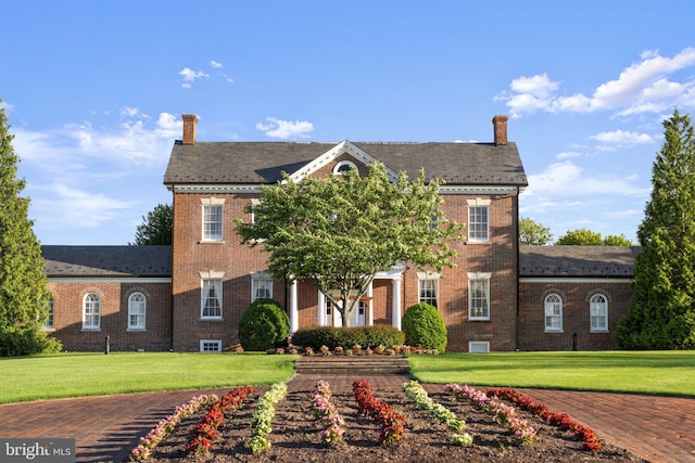 43433 Blair Park Sq, Ashburn, VA 20147 - colonial inspired home with a chimney, brick siding, and a front lawn