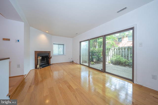 102 W Montgomery Ave Unit A, Ardmore, PA 19003 - unfurnished living room with light wood finished floors and a fireplace with flush hearth