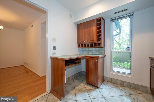 102 W Montgomery Ave Unit A, Ardmore, PA 19003 - bar area with built in study area, decorative backsplash, and light wood-style floors