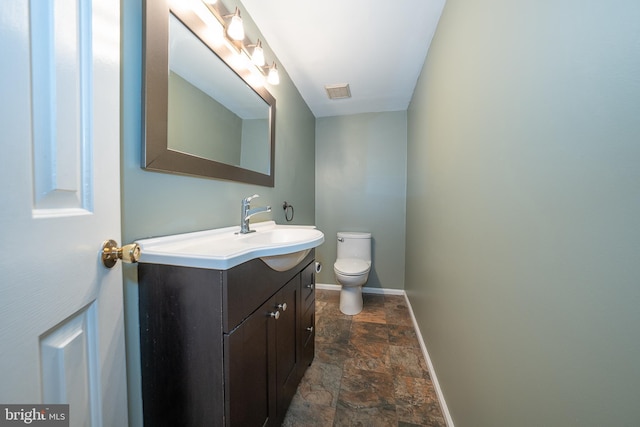 102 W Montgomery Ave Unit A, Ardmore, PA 19003 - half bathroom featuring stone tile floors, vanity, toilet, and baseboards