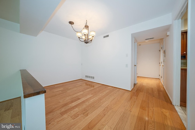 102 W Montgomery Ave Unit A, Ardmore, PA 19003 - unfurnished room featuring a chandelier and light wood-type flooring