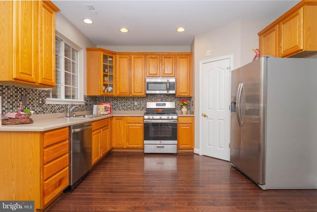 613 Berwick Ct, Abingdon, MD 21009 - kitchen featuring appliances with stainless steel finishes, a sink, dark wood finished floors, backsplash, and glass insert cabinets