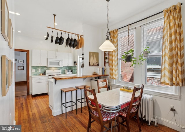 527 S 55th St, Philadelphia, PA 19143 - dining room featuring dark wood-style floors, baseboards, radiator, and recessed lighting