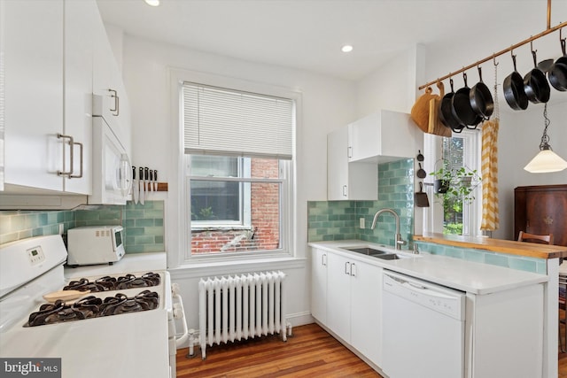 527 S 55th St, Philadelphia, PA 19143 - kitchen featuring radiator heating unit, white appliances, a sink, healthy amount of natural light, and recessed lighting