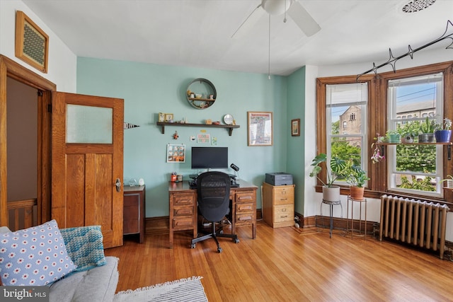 527 S 55th St, Philadelphia, PA 19143 - office space with radiator heating unit, wood finished floors, a ceiling fan, and baseboards
